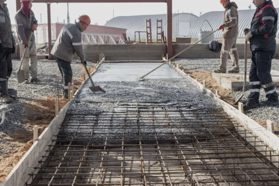 Fresh biochar-enhanced concrete being poured at a construction site